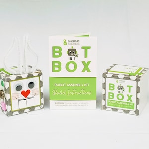 May include: A robot assembly kit in a box with a bunny rabbit design. The box has a green and white label with the text "Bot in a Box" and "Robot Assembly Kit".