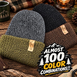 May include: Two knit beanies with folded cuffs. One beanie is a heathered gray with an olive green cuff, and the other is a solid black with a brown cuff. Each cuff features a tan leather-like tag embossed with the letters KH and a metal rivet.
