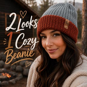 May include: A gray and rust-colored beanie with a leather tag. The text on the image reads "2 Looks 1 Cozy Beanie". The beanie is worn by a person with long brown hair, in an outdoor setting.