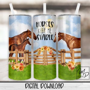 May include: A sublimation design for a tumbler featuring a watercolor illustration of two horses in a field with a wooden fence. The text "Horses Keep Me Stable" is printed on the tumbler.