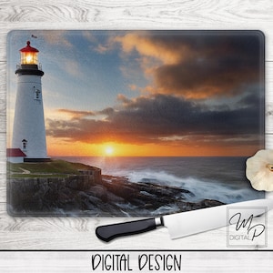 May include: Rectangular glass cutting board featuring a lighthouse scene at sunset. The lighthouse is white with a red top, set against a vibrant sky. A white chef's knife and a garlic bulb are also present.