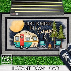 May include: A doormat with the text "Home is where the camper is" in black lettering. The doormat features a cartoon illustration of a vintage camper, a campfire, two chairs, and a lantern. The background is a dark blue with stars.