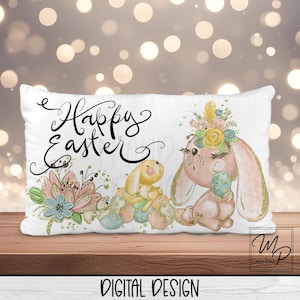 May include: A white cushion with the text "Happy Easter" in black lettering. The cushion features a pink bunny with a floral crown and a yellow bunny holding an egg. The background is a blurred image of lights.