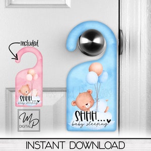 May include: Two door hangers featuring a cute cartoon bear holding balloons. The text on the hangers reads "SHHH... baby sleeping". One hanger is pink and the other is blue.