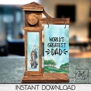 May include: A wooden sign with a golf bag and clubs on one side and the text "World's Greatest Dad" on the other side. The sign is on a wooden stand.