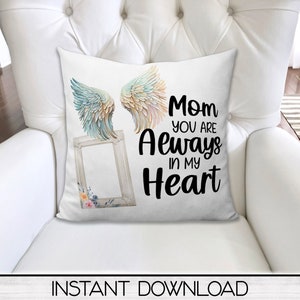 May include: White throw pillow with a watercolor design of angel wings and a picture frame. The text "Mom you are Always in my Heart" is printed in black.
