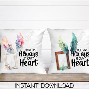 May include: Two white pillowcases with a watercolor design of angel wings and a picture frame. The text "You are Always in our Heart" is printed on each pillowcase.