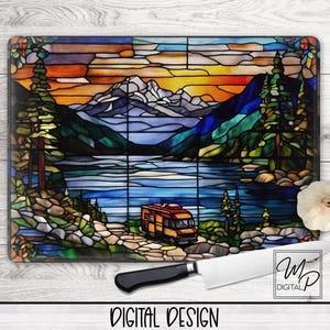 May include: A stained glass style cutting board with a sunset scene over a lake and mountains. A camper van is driving on a road leading to the lake. The cutting board is made of tempered glass and is dishwasher safe.