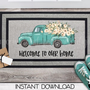 May include: A teal blue vintage pickup truck with a bed full of white flowers. The truck is on a gray doormat with the text "Welcome to our home".