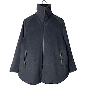 May include: A dark grey zip-up jacket with a high collar and a slightly rounded hem. The jacket has two pockets with black leather trim.