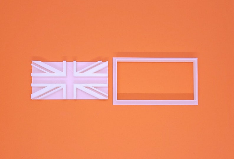 May include: A white Union Jack flag and a rectangular frame, set against an orange backdrop. The flag is a simplified design of the UK flag. The frame is a plain, empty rectangle.