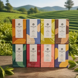 May include: Eight rectangular boxes of Osulloc tea arranged in two rows. Each box features a unique color, botanical illustrations, and the Osulloc logo. The labels include Korean and English text identifying various blended tea flavors and net weights.