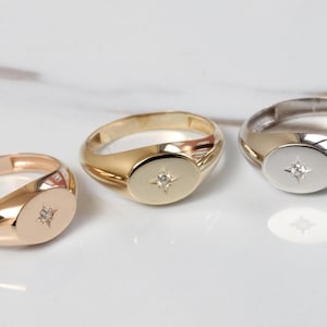 May include: Three signet rings with a single diamond set in the center of each. The rings are made of gold, silver, and rose gold.