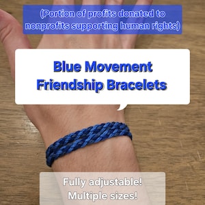 May include: Blue and black friendship bracelet made with braided cord. The bracelet is adjustable and comes in multiple sizes. A portion of profits are donated to nonprofits supporting human rights.