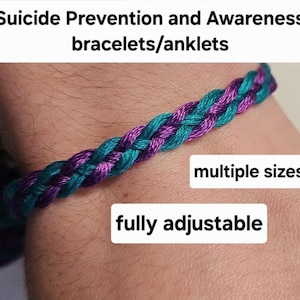 May include: A braided bracelet in teal and purple colors. The bracelet is adjustable and comes in multiple sizes. The text "Suicide Prevention and Awareness bracelets/anklets" is at the top of the image. The text "fully adjustable" is at the bottom of the image. The text "multiple sizes" is in the middle of the image.
