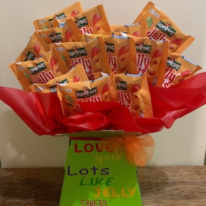 May include: A green and orange gift box with the text "LOVE you Lots Like JELLY TOTS" filled with small orange bags of Rowntrees Jelly Tots.