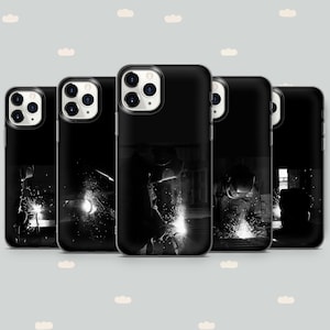 May include: Five black phone cases with a design of a welder working on a metal object. The cases have a black and white design with a focus on the sparks from the welding.