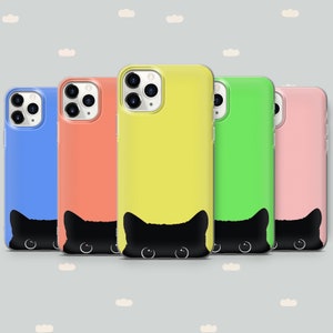 May include: Five phone cases with a black cat peeking out from the bottom. The cases are in different colors: blue, orange, yellow, green, and pink.