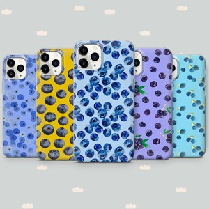 May include: Five different phone cases with blueberry designs. The cases are all for the iPhone 13 Pro Max. The designs feature blueberries on a light blue, yellow, purple, and light blue background.