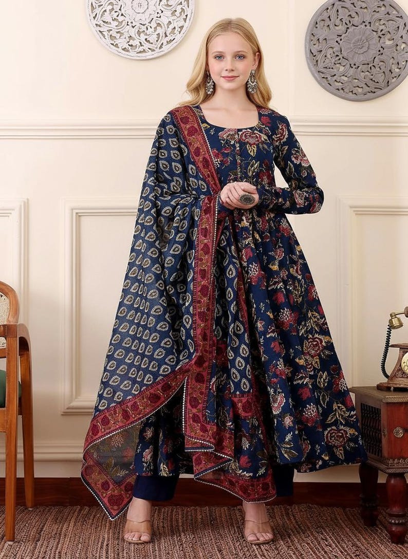 May include: A navy blue floral print dress with a matching shawl. The dress features long sleeves and a round neckline. The shawl has a patterned design with a burgundy border. The outfit is suitable for special occasions.