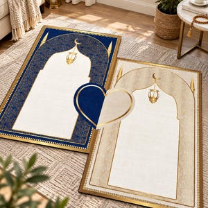 May include: Two rectangular prayer rugs featuring an arched mihrab design with a hanging lantern and crescent moon motif. One rug is deep blue with gold accents, and the other is cream with gold details. A heart-shaped icon overlays the center.