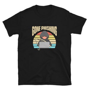 May include: Black t-shirt with a retro-style graphic of a hooded figure holding a laptop and fishing rod. The text "Gone Phishing" is above the graphic.