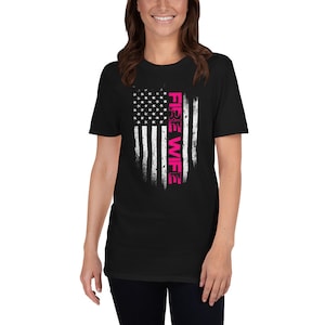 May include: Black t-shirt with a distressed American flag design and the text "FIRE WIFE" in pink.
