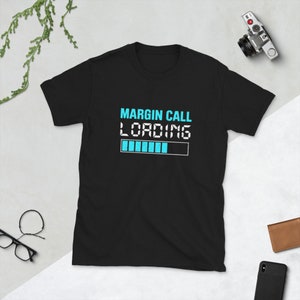 May include: Black t-shirt with a white graphic that says "MARGIN CALL LOADING" with a blue progress bar underneath.