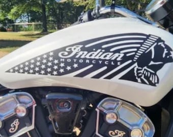 May include: A white motorcycle gas tank with a black and white graphic of an American Indian head, the words "Indian Motorcycle", and a stylized American flag.