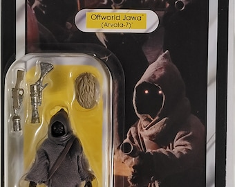 May include: A Star Wars The Mandalorian action figure of an Offworld Jawa from Arvala-7. The figure is in a plastic blister pack with a yellow background. The figure is wearing a brown hooded robe and has a red glow in its eyes. The figure comes with a blaster rifle and a Jawa head accessory. The packaging also features the Kenner logo.