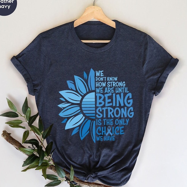 Camisa de concientización sobre el cáncer de colon, camisetas gráficas con cinta contra el cáncer, camisas de apoyo al cáncer, regalo para sobrevivientes de cáncer de próstata, camiseta más fuerte que el cáncer