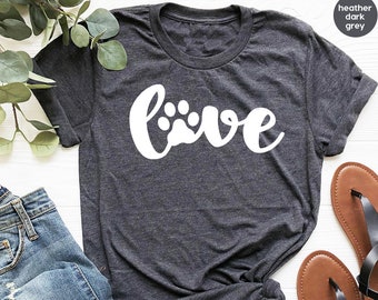 May include: Heather dark grey t-shirt with the word "love" in white with a paw print in the "o".