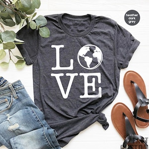 May include: A heather dark grey t-shirt with the word "LOVE" printed in white. The "O" in LOVE is replaced with a graphic of the Earth.