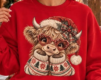 May include: A bright red crewneck sweatshirt featuring a graphic of a fluffy Highland cow wearing a Santa hat with a plaid bow, heart-shaped red glasses, and patterned mittens with a snowflake and tree design on the front center.