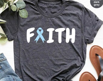 May include: Heather dark grey t-shirt with the word "FAITH" in white letters and a light blue ribbon in the middle of the word.