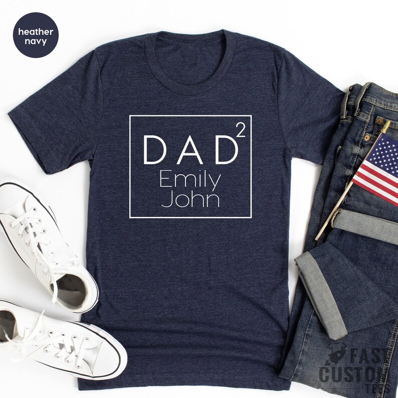 May include: A heather navy blue t-shirt with a white square design that says "DAD&sup2; Emily John".