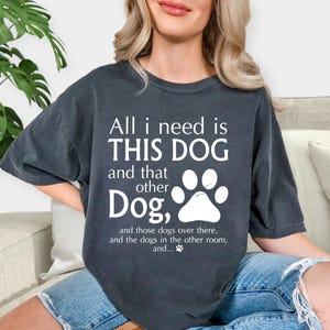 A woman wearing a black t-shirt with a humorous text printed on it.