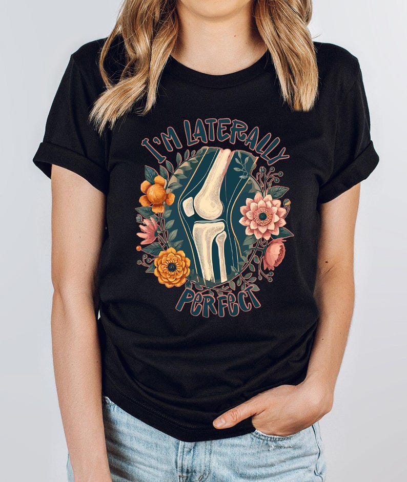 a woman wearing a black t - shirt with a picture of a woman's