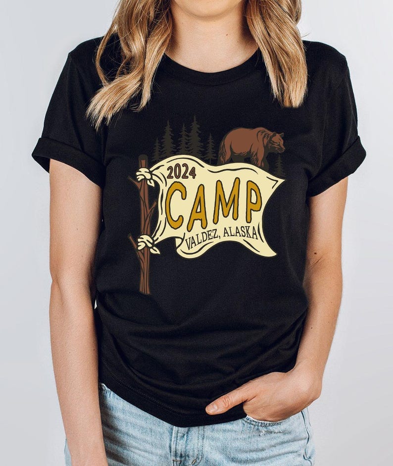 a woman wearing a black t - shirt that says camp