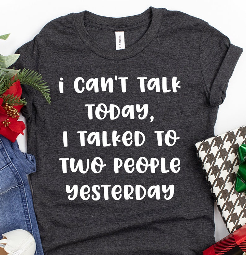 May include: A dark gray t-shirt with white text that reads "i can't talk today, i talked to two people yesterday".