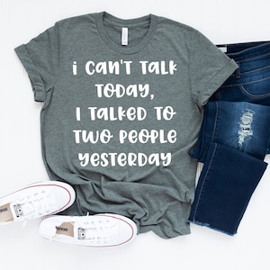 May include: A heather gray t-shirt with the text "i Can't Talk TODAY, I TALKED TO TWO PEOPLE YESTERDAY" printed in white.