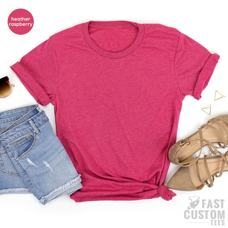 May include: A heather raspberry colored t-shirt with a crew neck and rolled up sleeves. The t-shirt is laid flat on a white background.