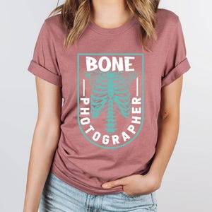 a woman wearing a t - shirt with a skeleton on it