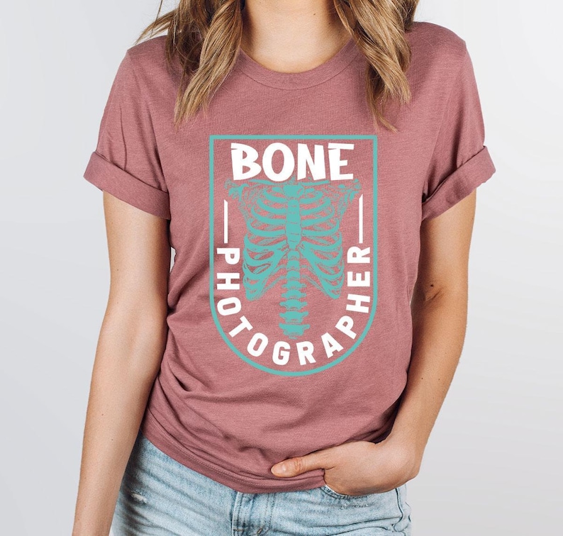 a woman wearing a t - shirt with a skeleton on it