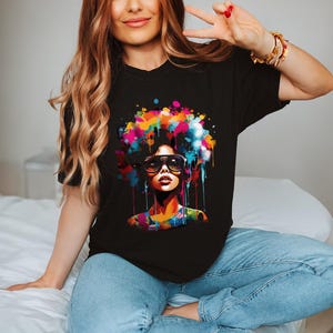 a woman sitting on top of a bed wearing a black shirt