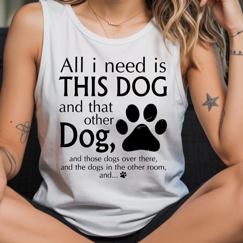 A woman wearing a white tank top with a humorous text printed on it.