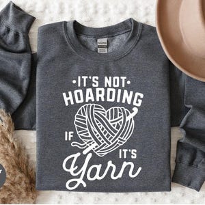 a gray shirt that says it's not hoarding if it's yarn