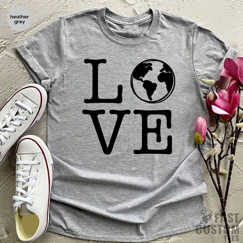 May include: Heather grey t-shirt with the word "LOVE" in black text. The "O" in LOVE is replaced with a black and white image of the Earth.