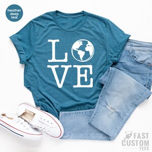 May include: A teal blue t-shirt with the word "LOVE" in white text. The "O" in LOVE is replaced with a white outline of the Earth.