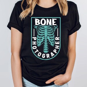 a woman wearing a black shirt with a skeleton on it